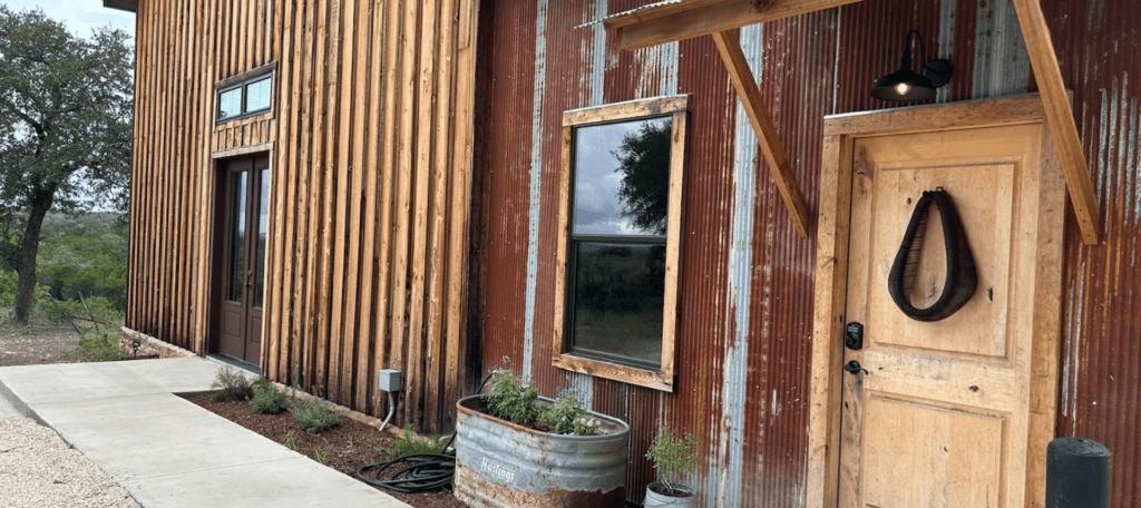 Inn_at_Sunset_Mill_Ranch_Texas_Hill_Country_Hotel_Granary_Room_exterior - Inn at Sunset Mill Ranch Image of entrance into barn room at Inn at Sunset Mill Ranch