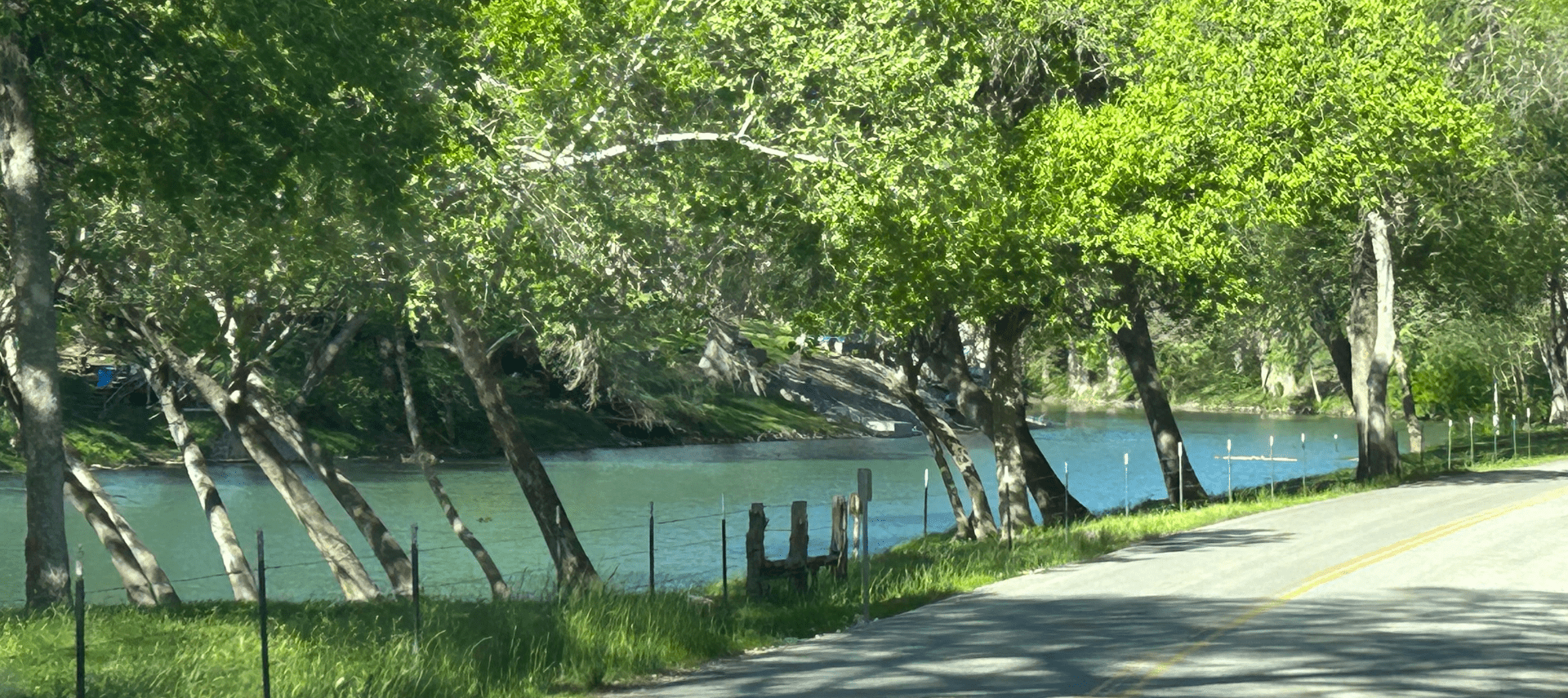Image of view from truck windshield of blanco river on drive