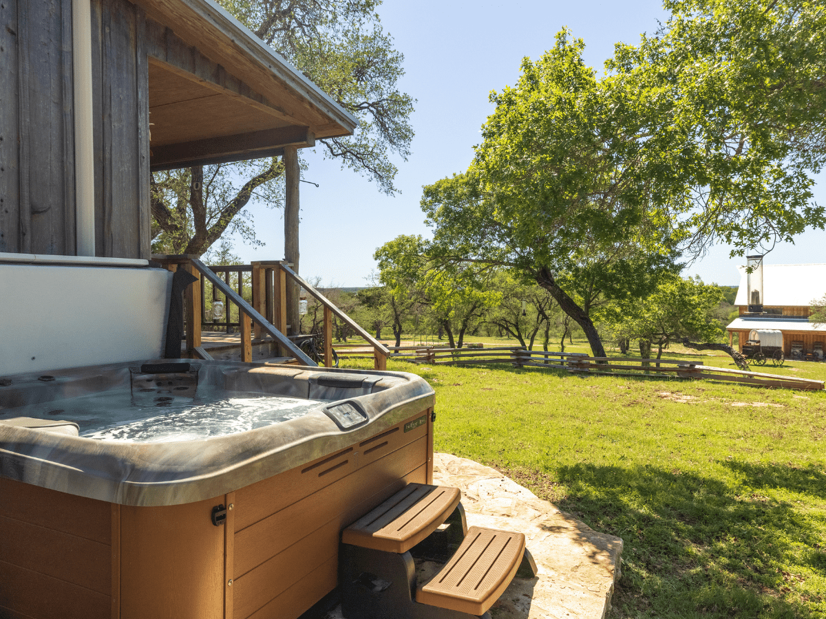 Image of hot tub on back patio of Cabin at Inn at Sunset Mill ranch