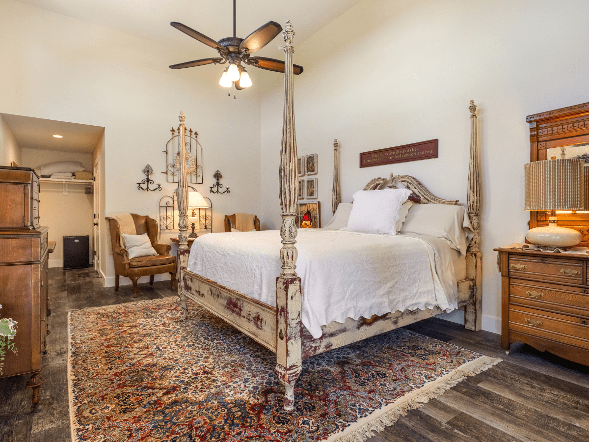 Inn_at_Sunset_Mill_Ranch_Wimberley_Hotel_mill_room - Inn at Sunset Mill Ranch Image of four poster king bed in lodging room in Wimberley texas at Inn at Sunset Mill Ranch