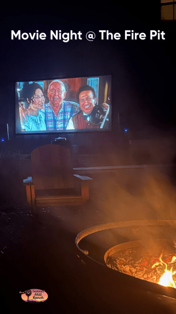 Rise-and-Shine-2 - Inn at Sunset Mill Ranch image of outdoor theater playing a movie with a firepit and adirondak chair