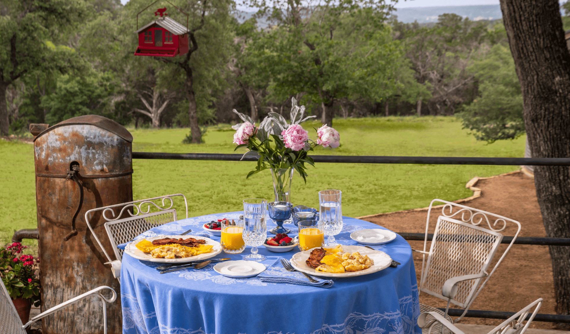 Inn_At_Sunset_Mill_Ranch_Wimberley_Hotel_Lodging_Bed_and_Breakfast - Inn at Sunset Mill Ranch Image of breakfast patio table overlooking texas hill country views at Inn at Sunset Mill Ranch bed and breakfast