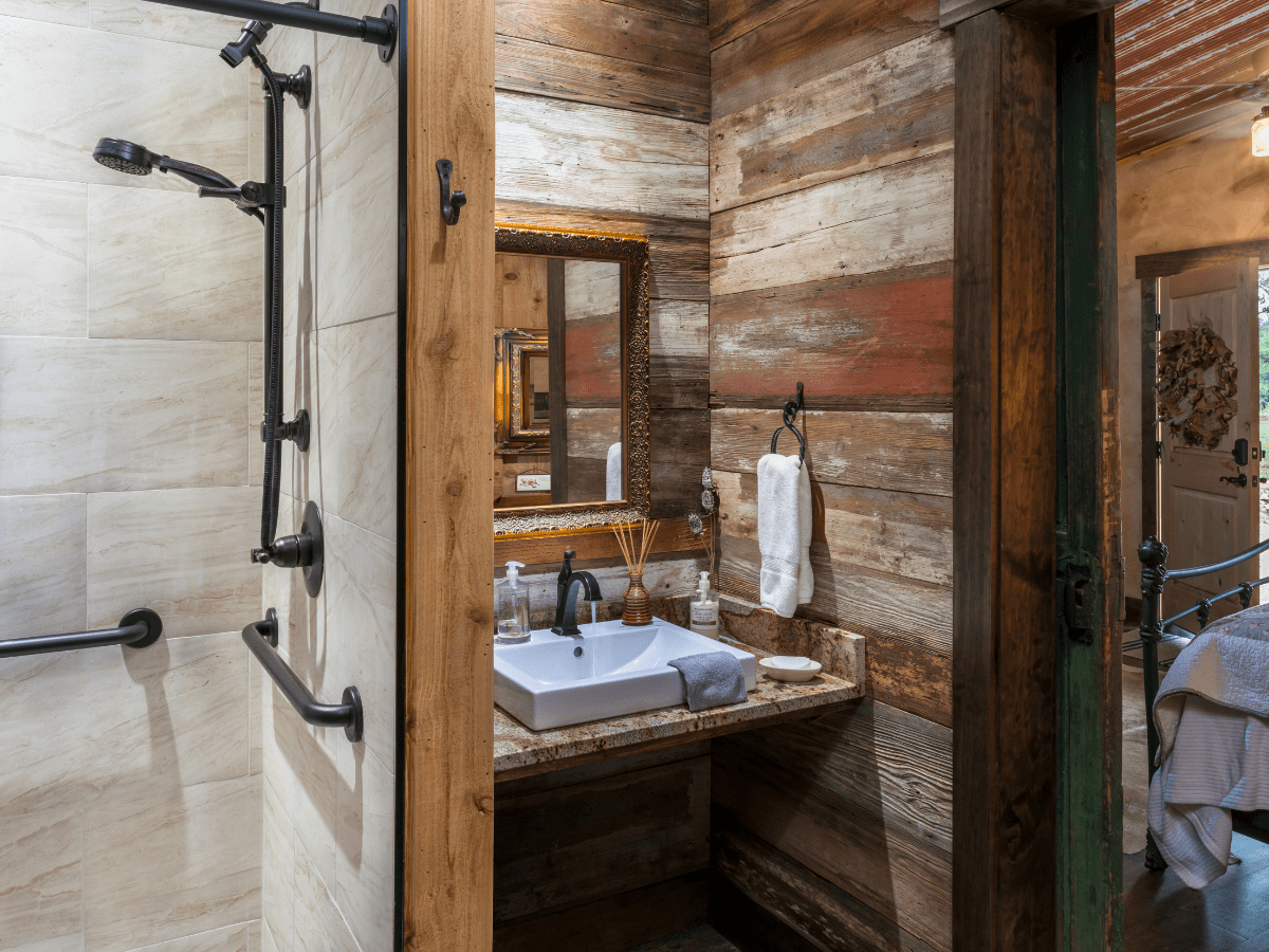 Inn_at_Sunset_Mill_Ranch_Wimberley_Hotel_granary_room 2 - Inn at Sunset Mill Ranch Image of bathroom with barnwood walls at wimberley lodging inn at sunset mill ranch