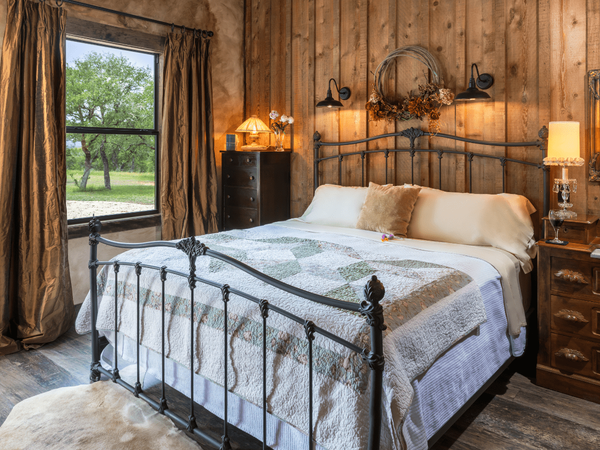 Inn_at_Sunset_Mill_Ranch_Wimberley_Hotel_granary_room 3 - Inn at Sunset Mill Ranch Image of king bed in hotel room in Texas hill country