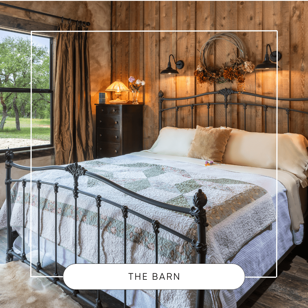 Sunset_Mill_Ranch_Texas_Hill_Country_Bed_And_Breakfast - Inn at Sunset Mill Ranch Image of king bed with barn wood wall and picture window at texas hill country resort Inn at Sunset Mill Ranch